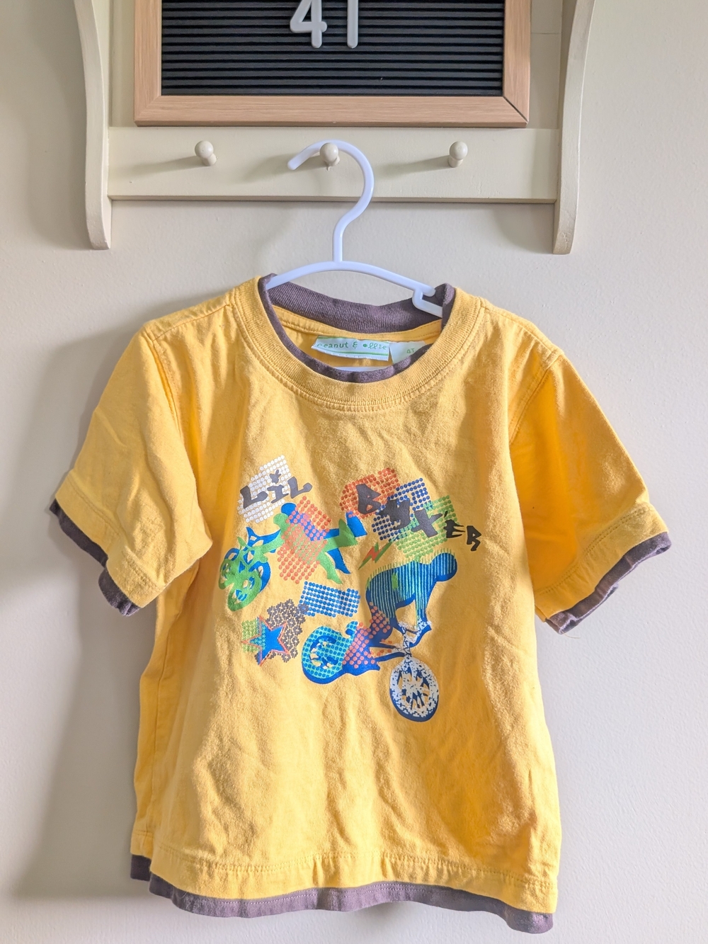 Peanuts Yellow Tee with Multicolor Bike Graphic and Brown Trim